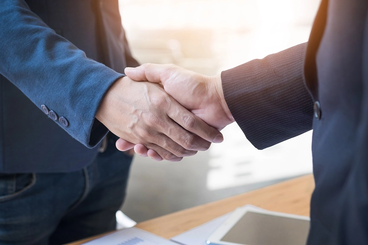 close up of a business man handshake in a professional setting