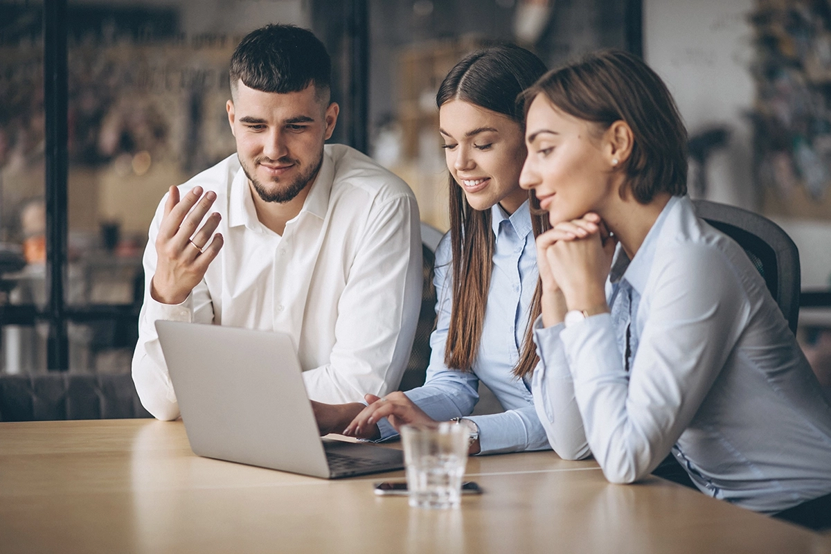 business team collaborating on a laptop